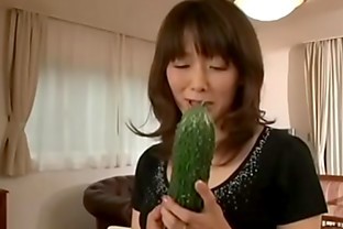 Japanese mother masturbating with a big cucumber